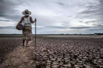 Woman standing on a drought land